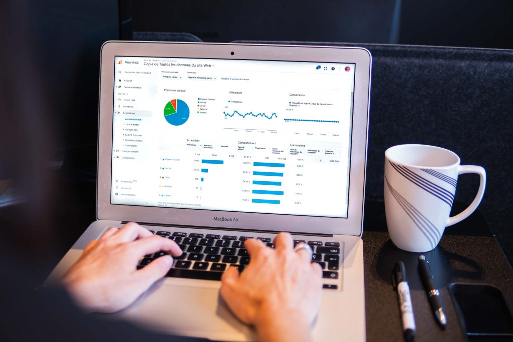 A laptop screen showing metrics, graphs, and charts